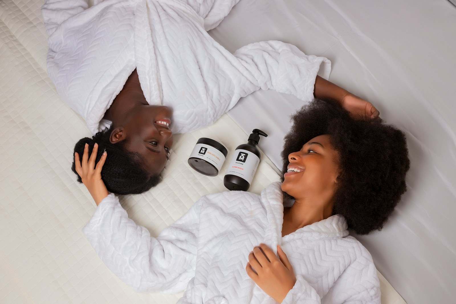 a man and a woman laying on a bed next to each other